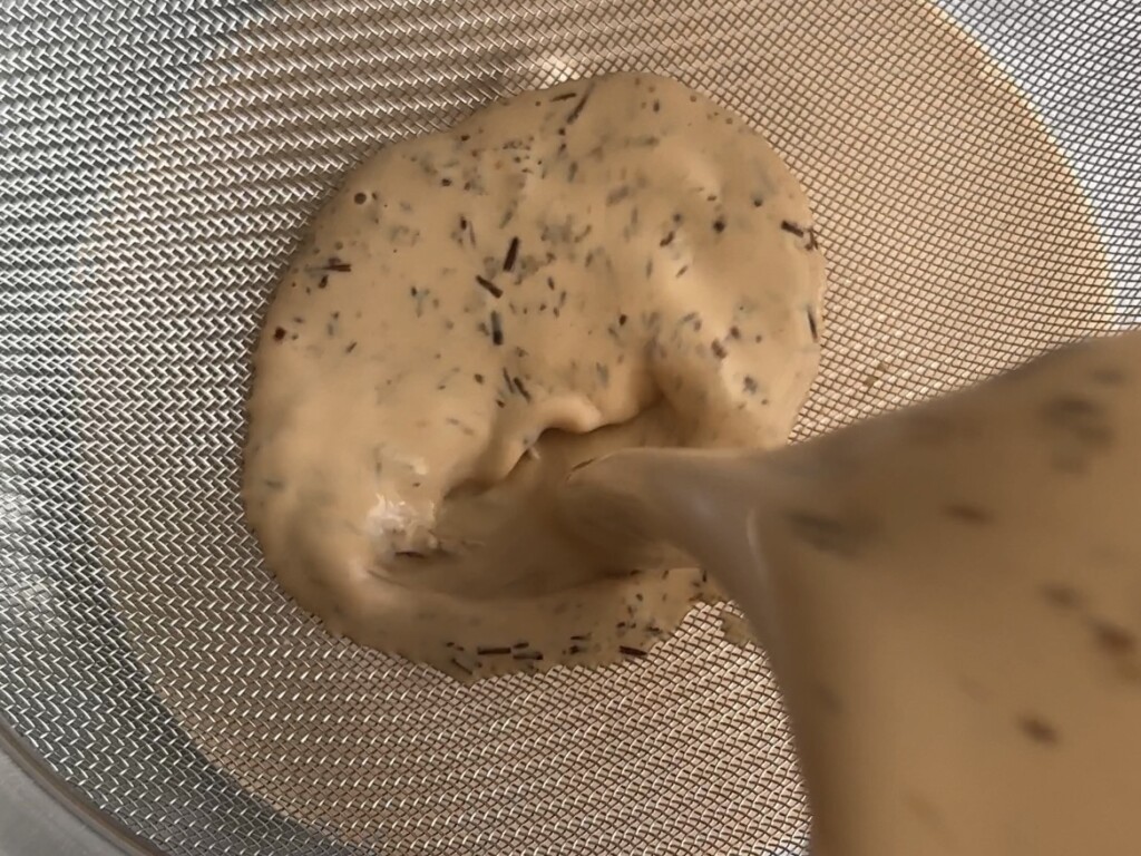 Straining the tea leaves from the heavy cream for the no-churn ice cream