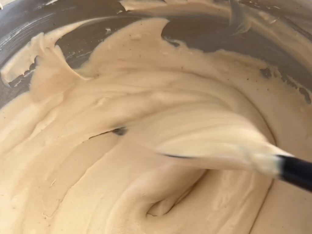 Folding condensed milk into the rooibos infused heavy cream for the no churn ice cream