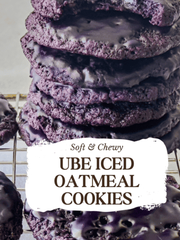 Stacked ube iced oatmeal cookies on a cooling rack