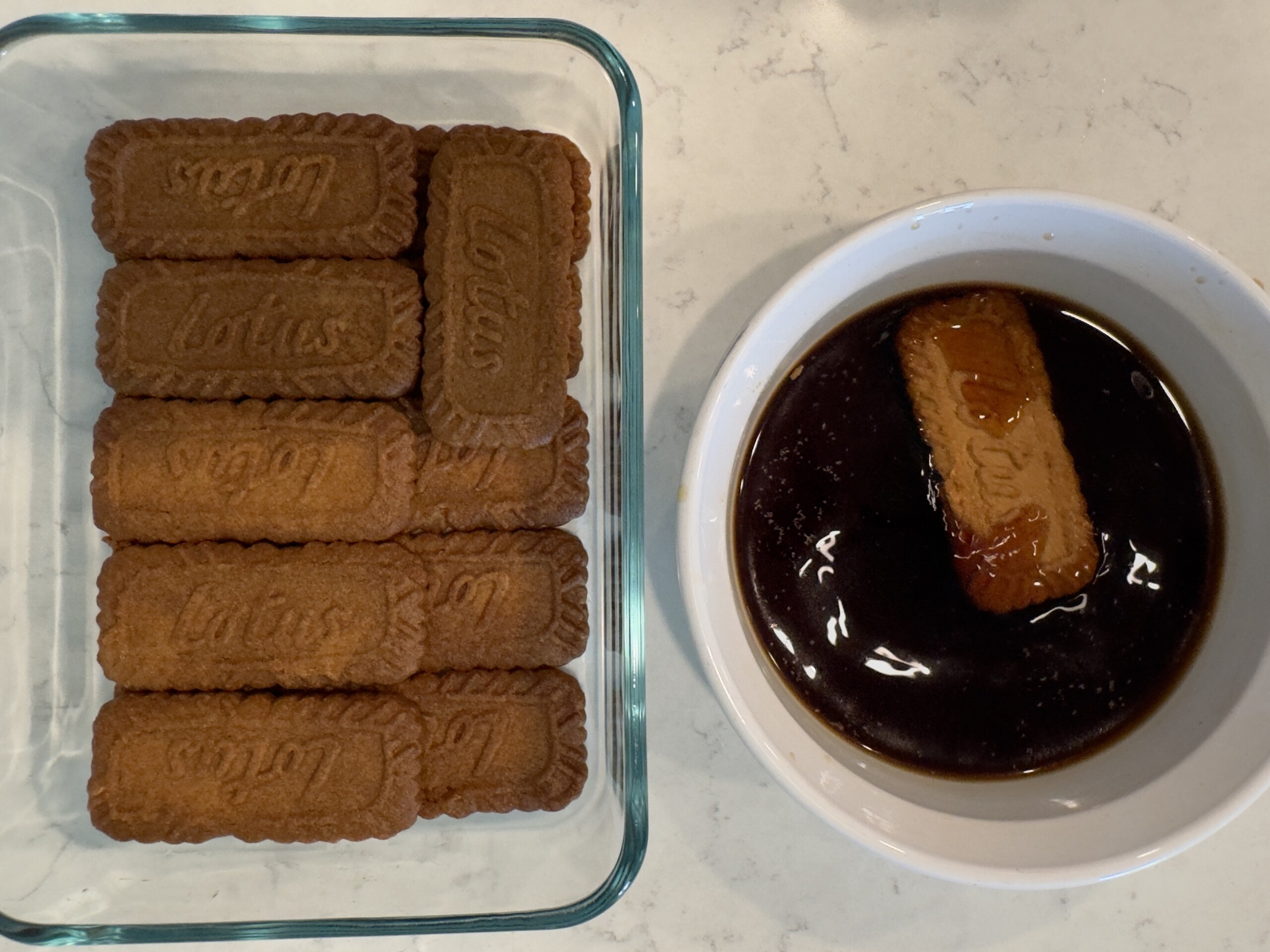 Speculoos cookies dipped in coffee and assembled in the bottom layer of container