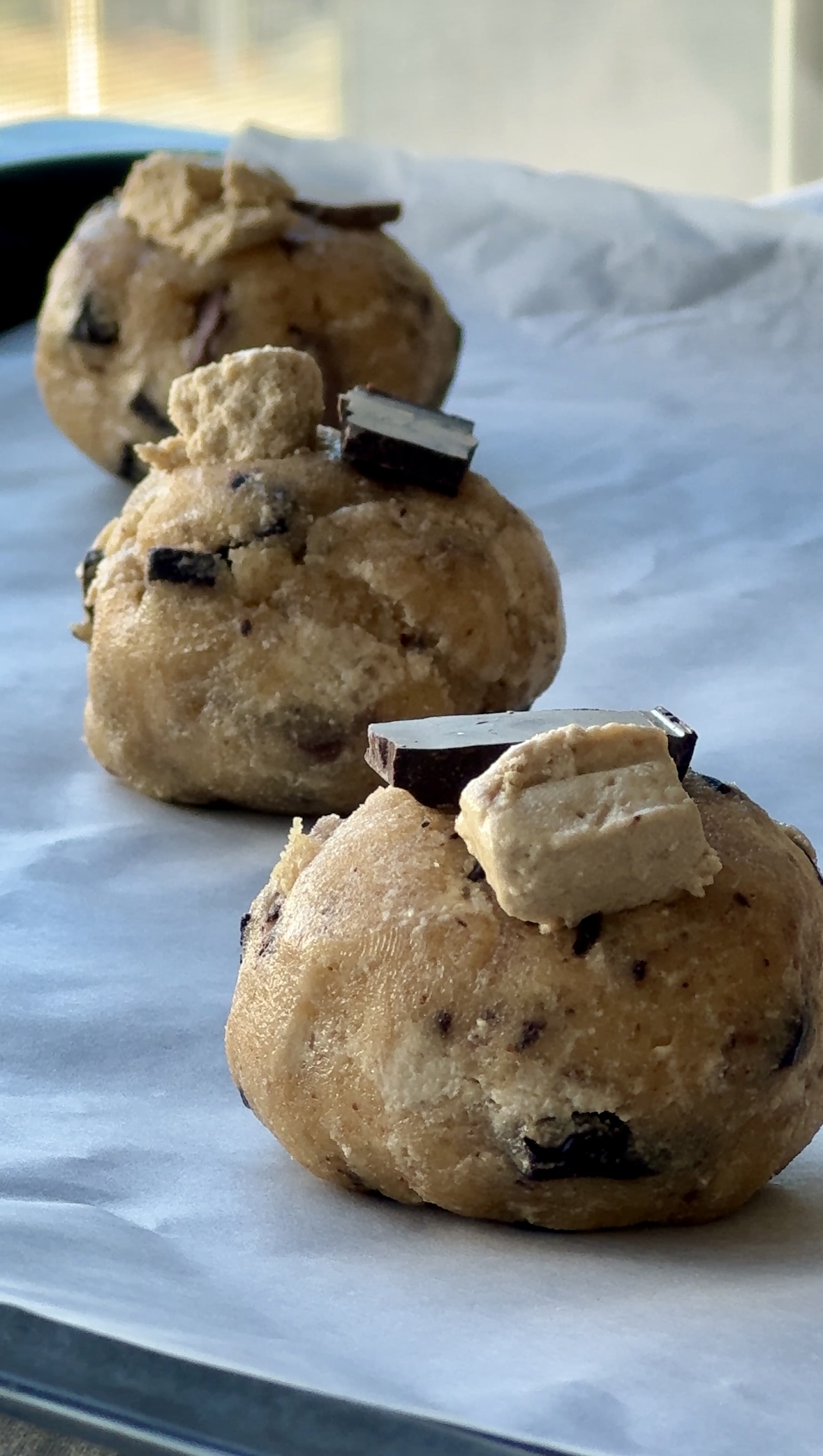 Brown butter halva chocolate chunk cookie dough balls topped with halva and chocolate