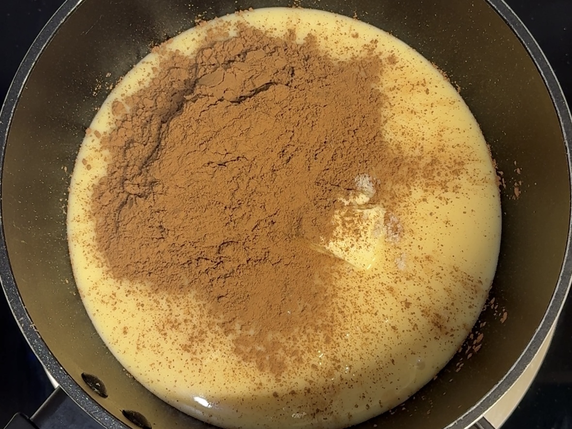 Condensed milk, butter, cocoa powder, and salt in pot