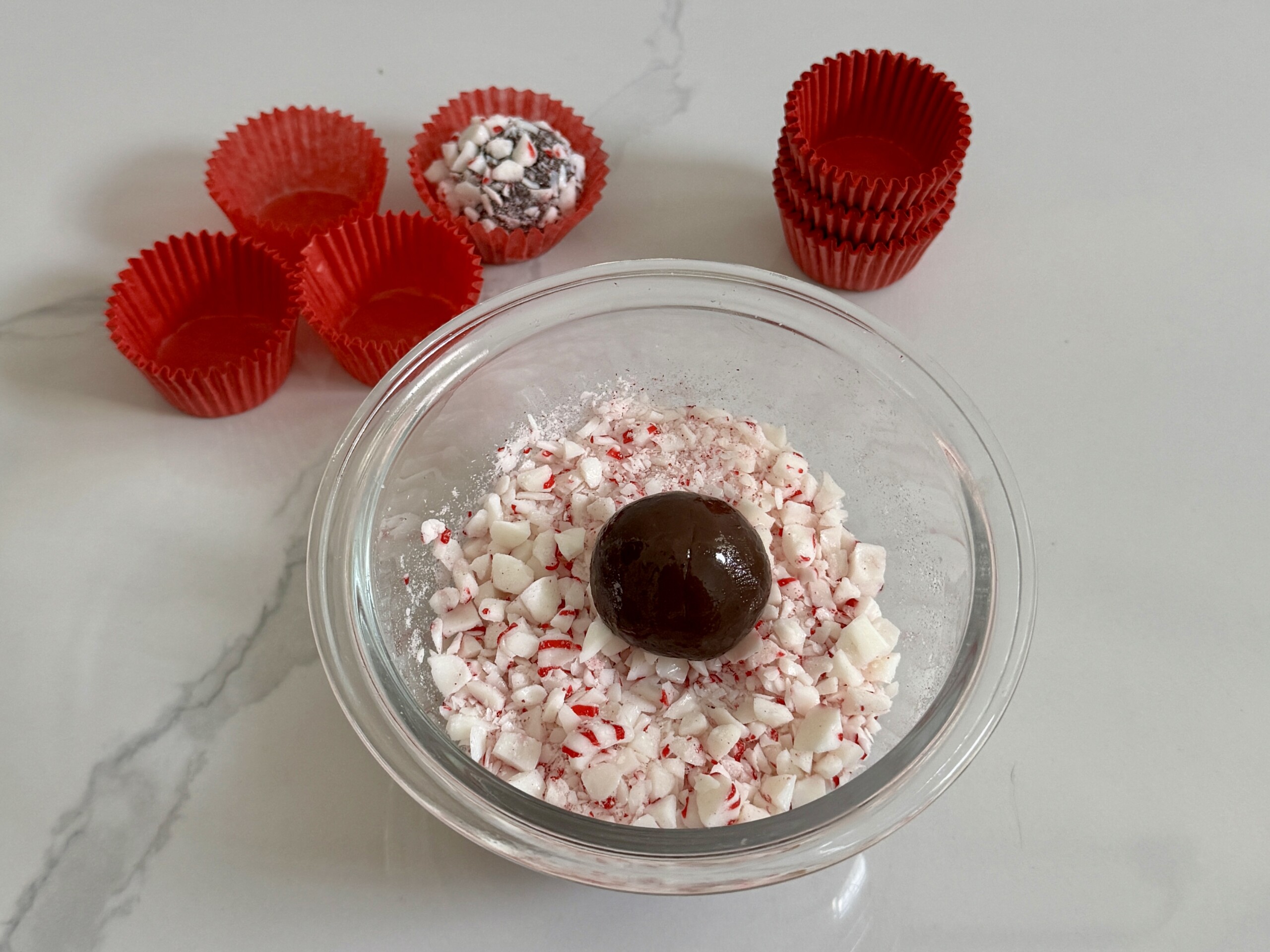 Brigadeiro rolled into a ball and on top of peppermint candy
