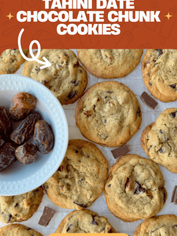 Tahini Date Chocolate Chunk Cookies on parchment paper with chocolate chunks in between and a bowl of dates to the left side