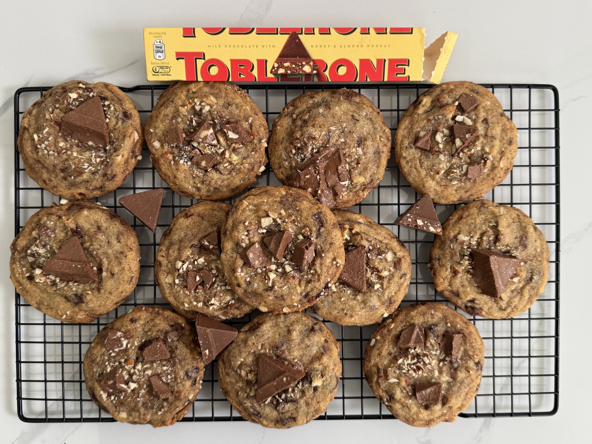 Brown Butter Almond Honey Toblerone Cookies on a cooling rack