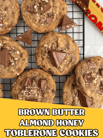 Brown Butter Almond Honey Toblerone Cookies on a cooling rack with a Toblerone package