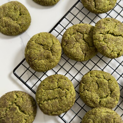 Matcha snickerdoodles on top of cooling rack and counter