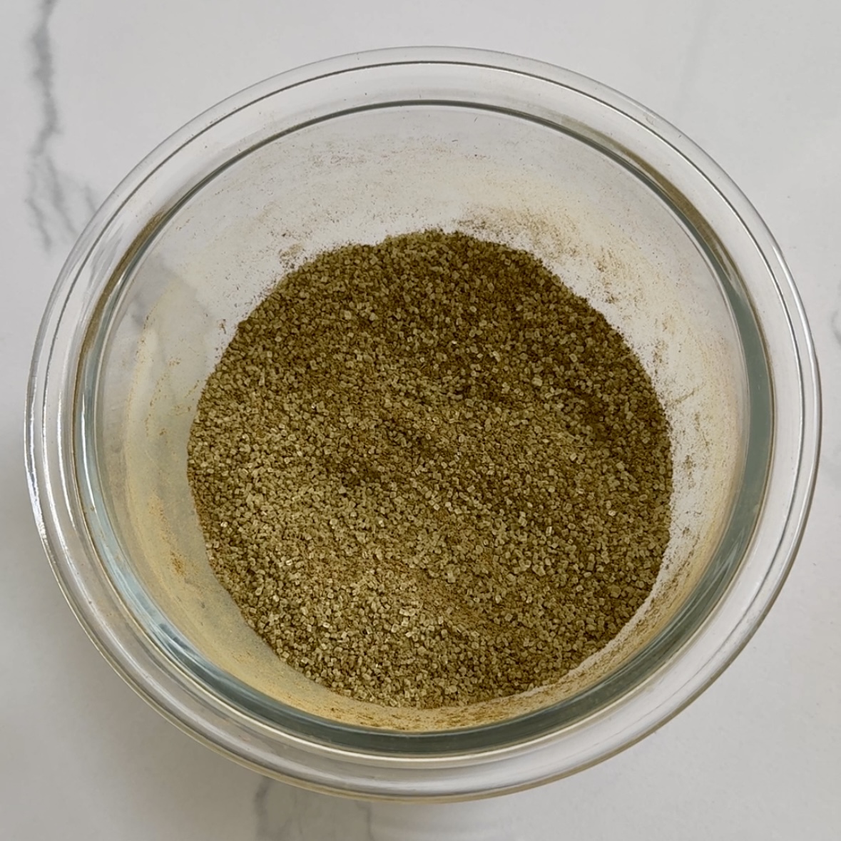 Matcha cinnamon sugar mixture in small glass bowl