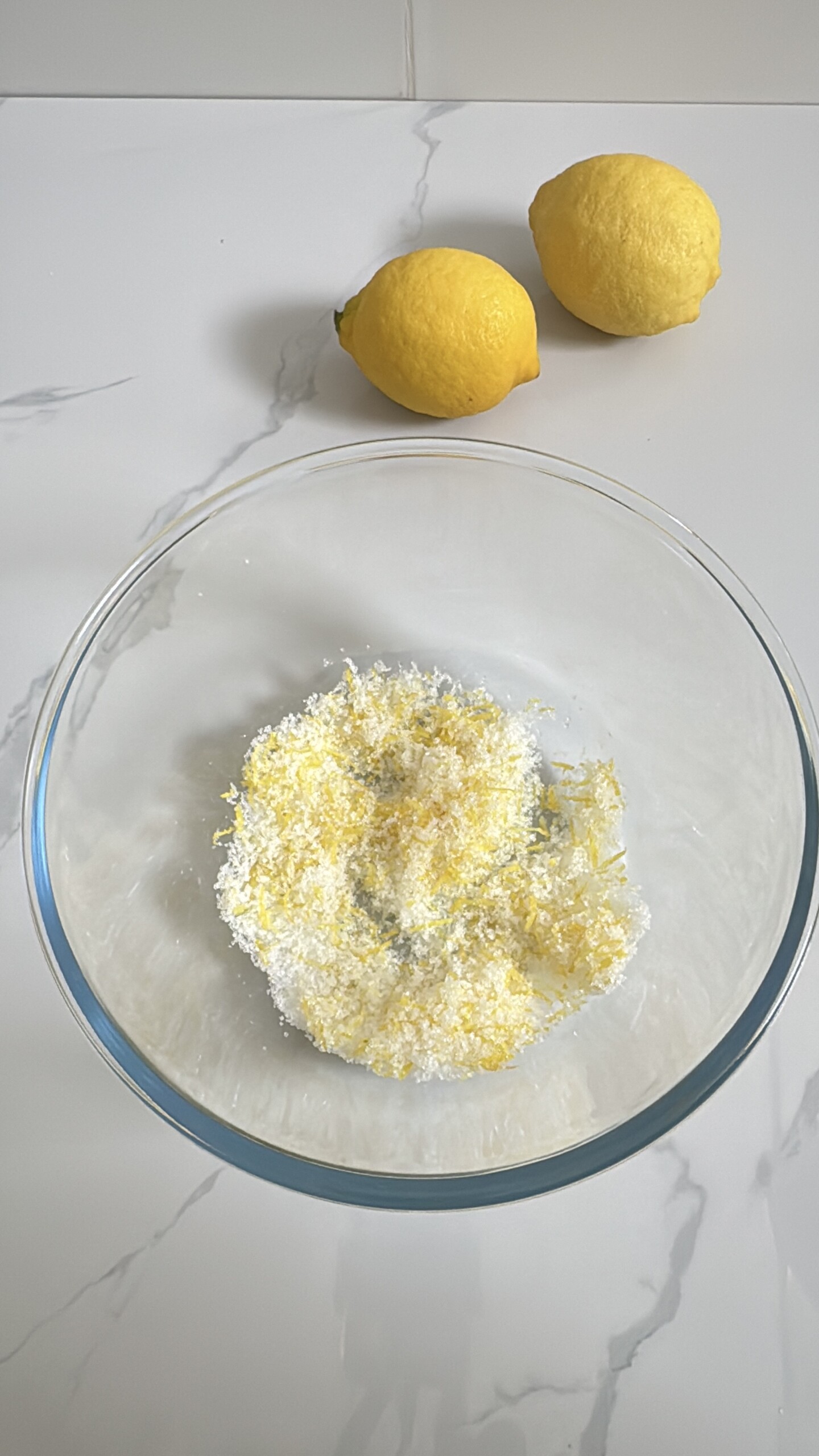 Lemon sugar mixed in glass bowl